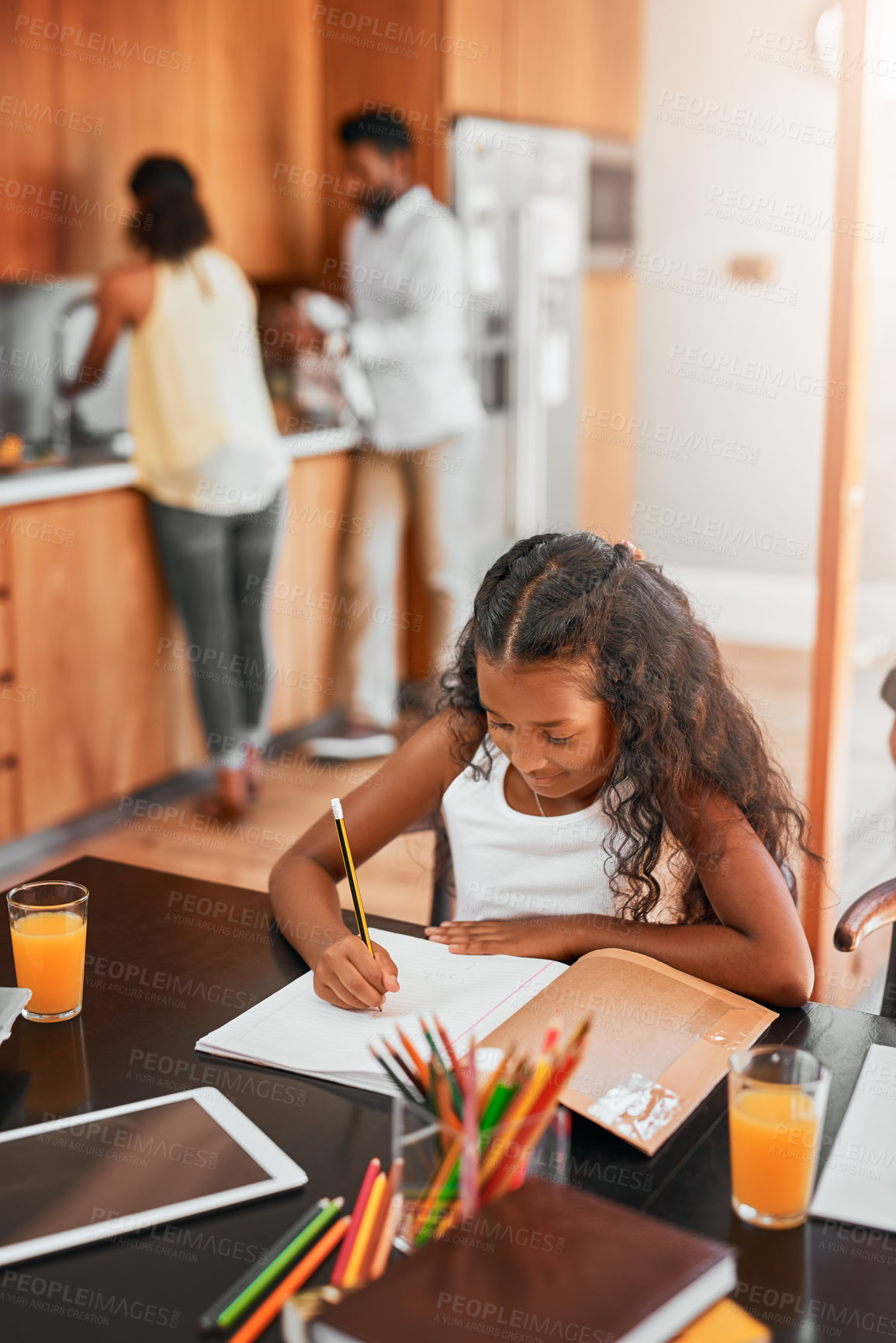 Buy stock photo Little girl, writing and homework with book for morning, learning or education on kitchen table. Young female person, child or kid drawing for assessment, creativity or childhood development at house