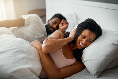 Buy stock photo Cropped shot of a beautiful wife annoyed by her handsome husbands snoring in bed at home