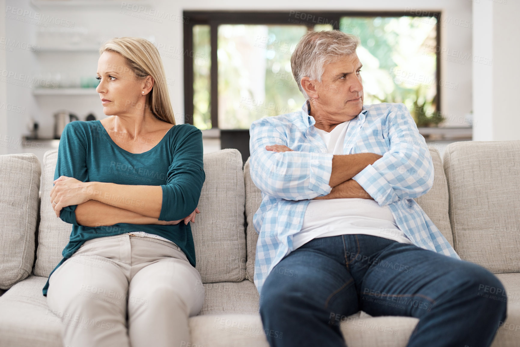 Buy stock photo Mature, married and couple fight on sofa in home, people and domestic issue or ignore for infidelity. Crossed arms, frustrated and conflict in living room together, divorce and relationship drama