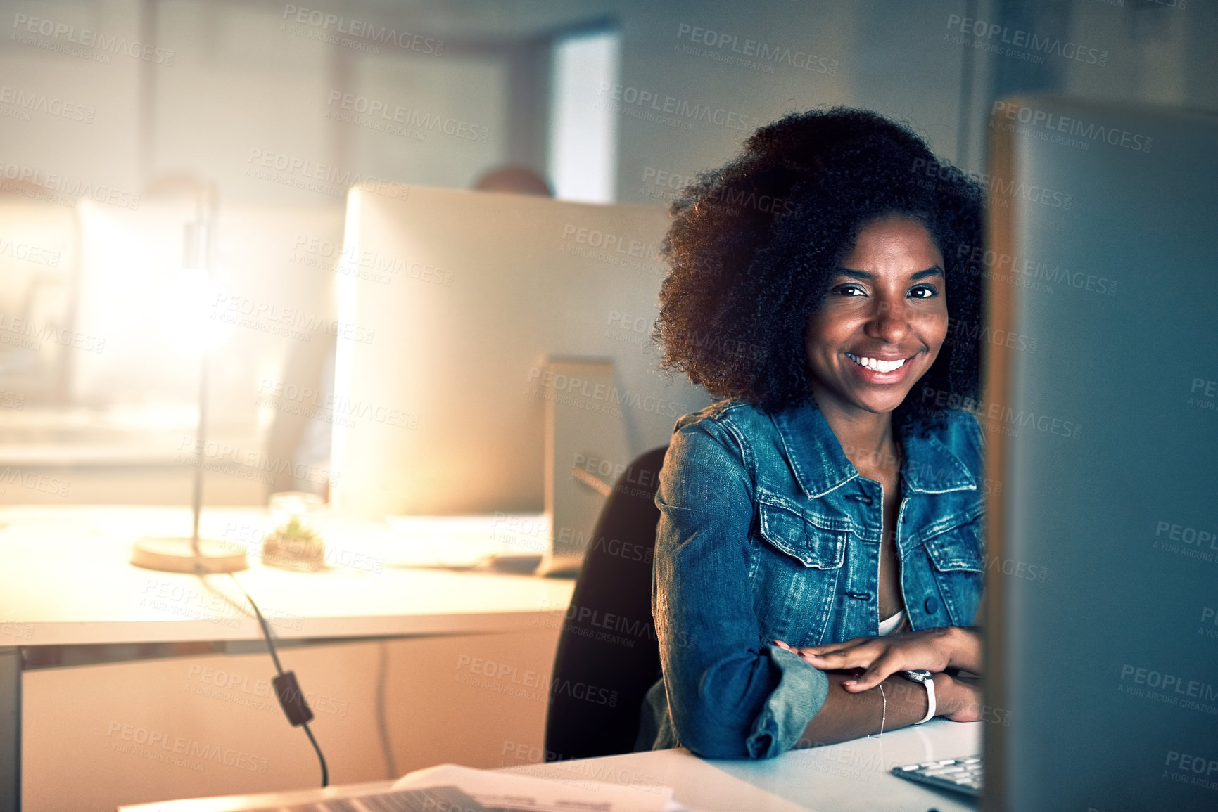 Buy stock photo Portrait of a young businesswoman working late on a computer in an office