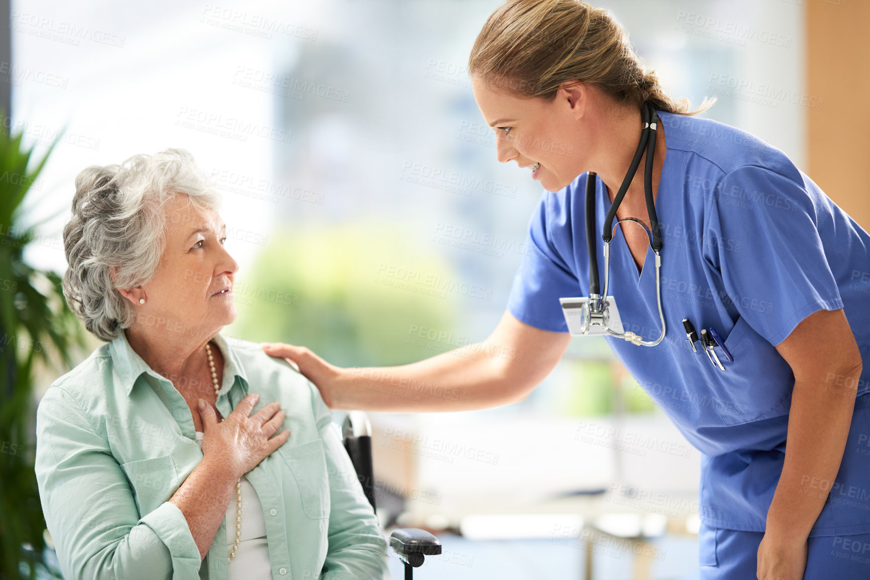 Buy stock photo Cropped shot of a female carer at a nursing home with her senior patient