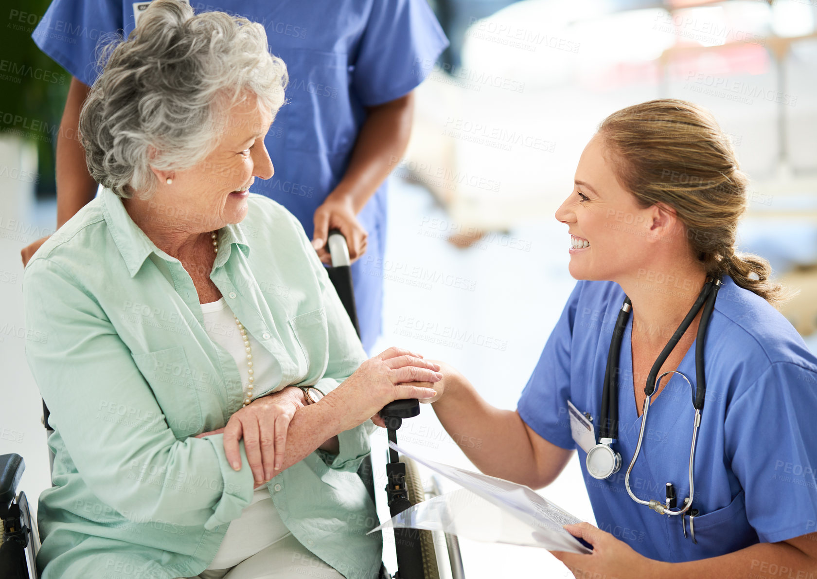Buy stock photo Cropped shot of an attractive female nurse discussing treatments with her wheelchair-bound senior patient in the hospital