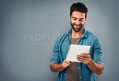 Buy stock photo Man, tablet and scroll by white background with smile for social media, internet or website search. Fashion designer, happy and technology for b2b ecommerce, startup and online or digital catalog