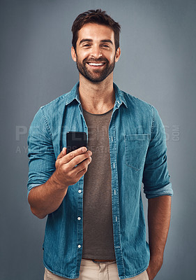 Buy stock photo Cellphone, smile and portrait of man in studio, communication and social media on gray background. Internet, online and scroll for texting on dating app, talk or happy male person on mobile for love