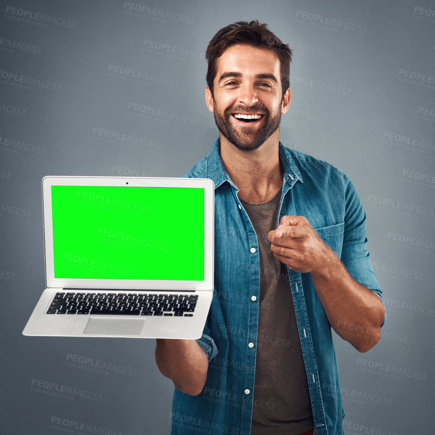 Buy stock photo Happy man, laptop and pointing with green screen in advertising or marketing against a grey studio background. Portrait of male person showing computer display, mockup or copy space for advertisement