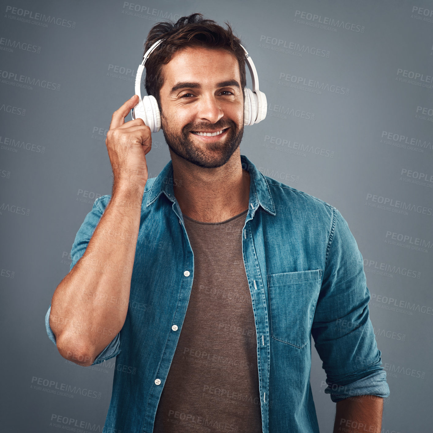 Buy stock photo Portrait, man and headphone for music in studio, audio media and podcast or ebook on gray background. Technology, streaming and online subscription for song, male person and smile for listening