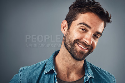 Buy stock photo Studio portrait of a handsome young man posing against a grey background