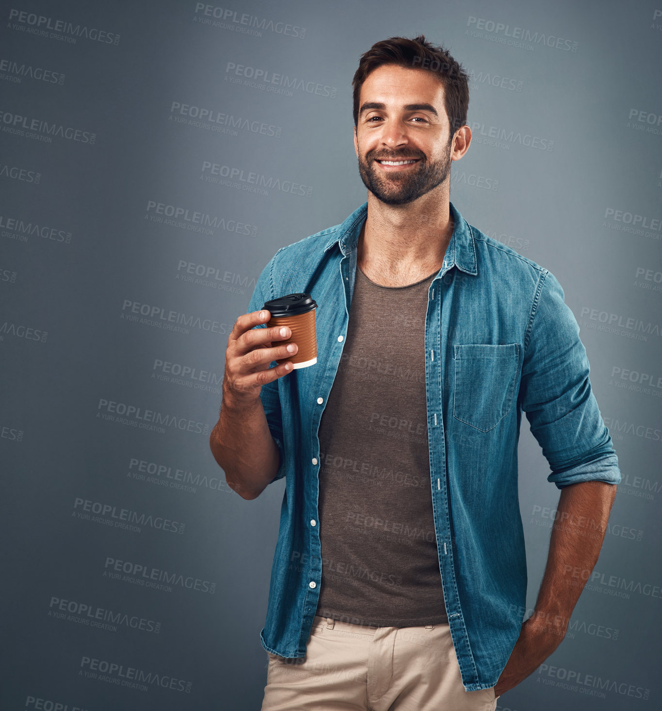 Buy stock photo Studio shot of a handsome young man drinking a cup of coffee against a grey background