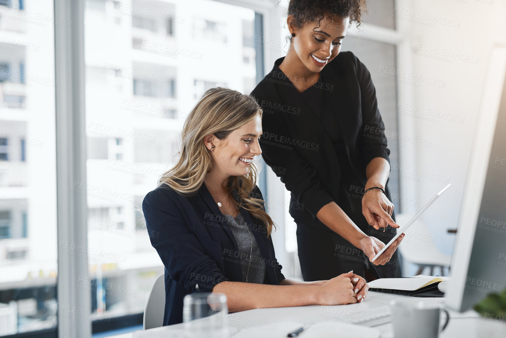 Buy stock photo Shot of two businesswomen working together in an office