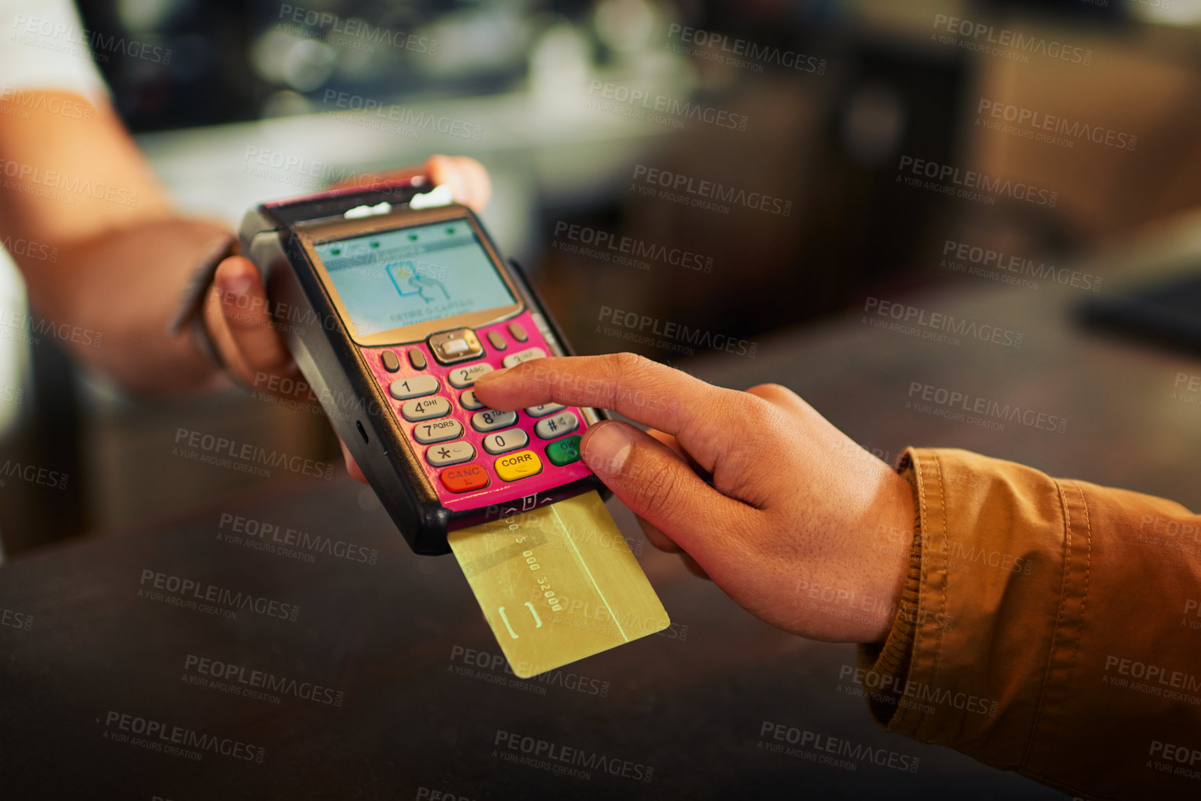 Buy stock photo Closeup of an unrecognizable person paying their bill with a card machine inside of a restaurant during the day