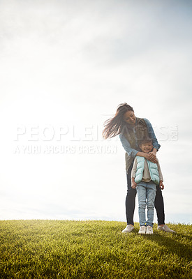 Buy stock photo Shot of a mother embracing her daughter from behind