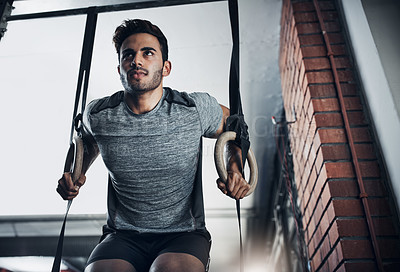 Buy stock photo Shot of a handsome young man working out at the gym