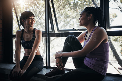 Buy stock photo Shot of two friends chatting while out for a workout at the gym