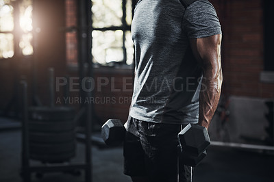 Buy stock photo Cropped shot of an unrecognizable man working out with dumbbells