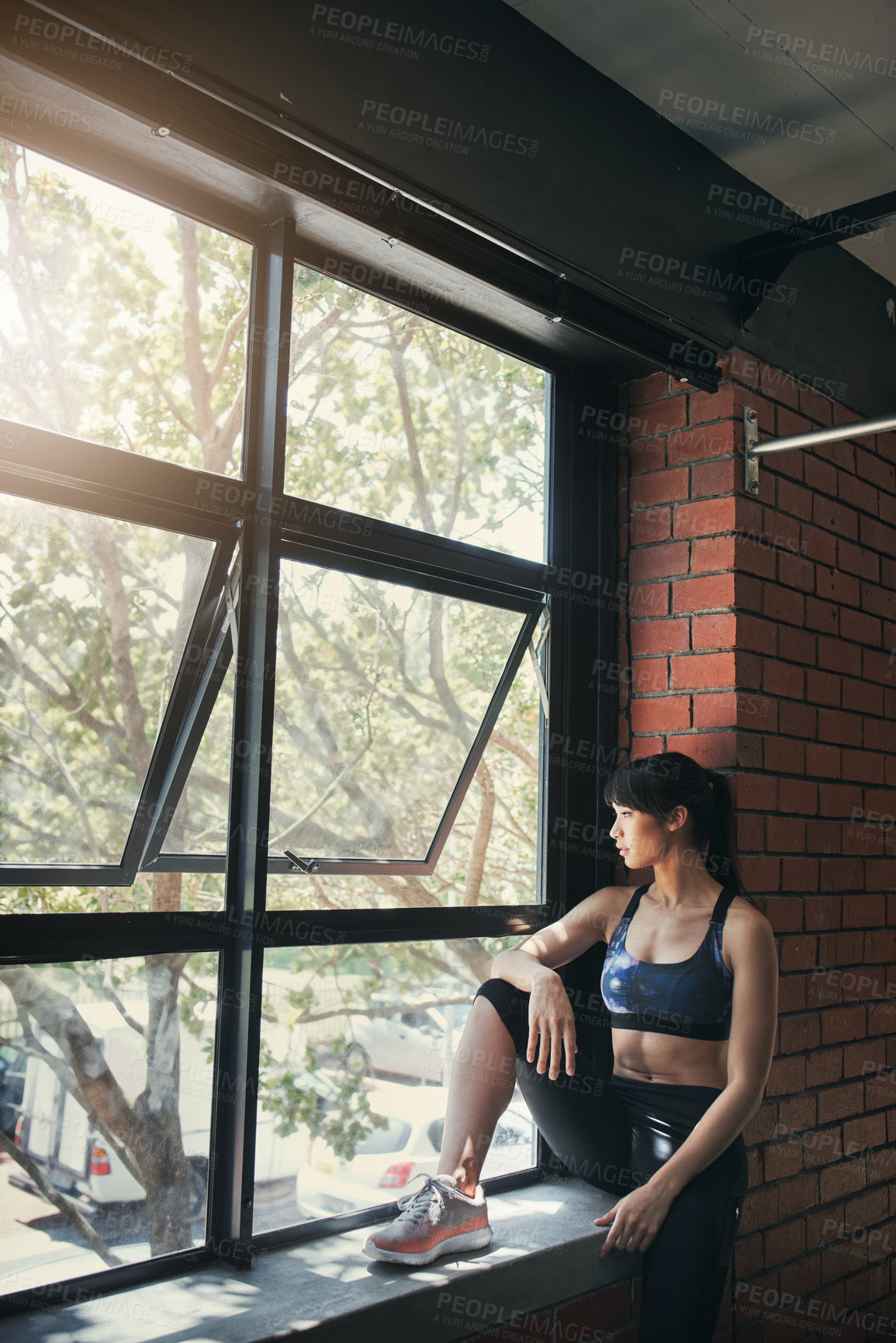 Buy stock photo Shot of a beautiful young woman sitting at the gym