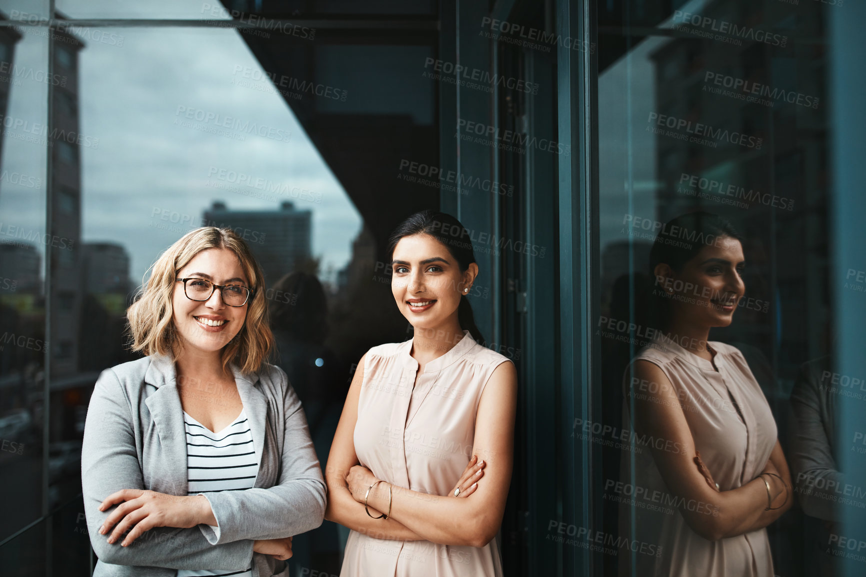 Buy stock photo Portrait of two young businesswoman standing on the office balcony