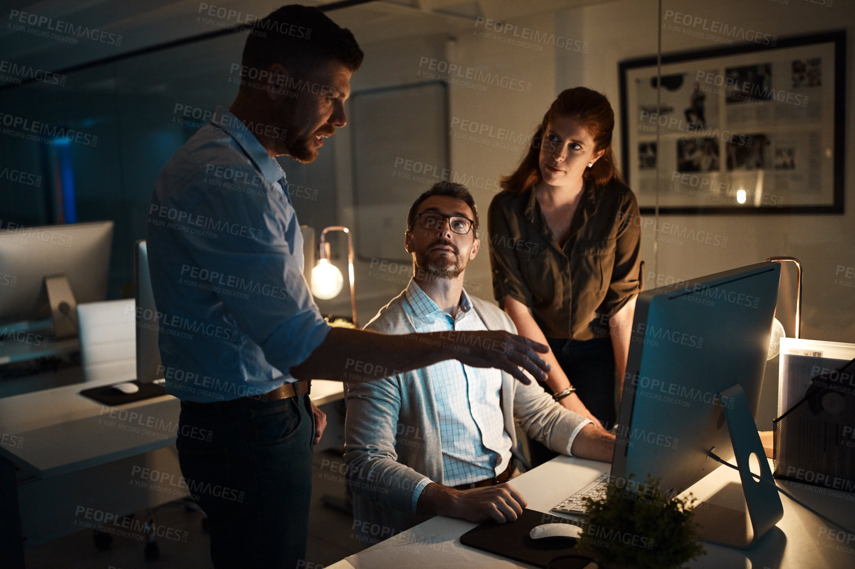 Buy stock photo Shot of a group of businesspeople working late in an office