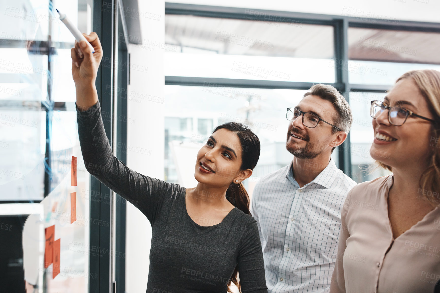 Buy stock photo Woman, teamwork and office with writing on glass board with notes, discussion and planning with brainstorming. Coach, training and group by wall, synergy and collaboration with strategy in workplace