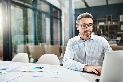 Buy stock photo Shot of a mature businessman working in an office