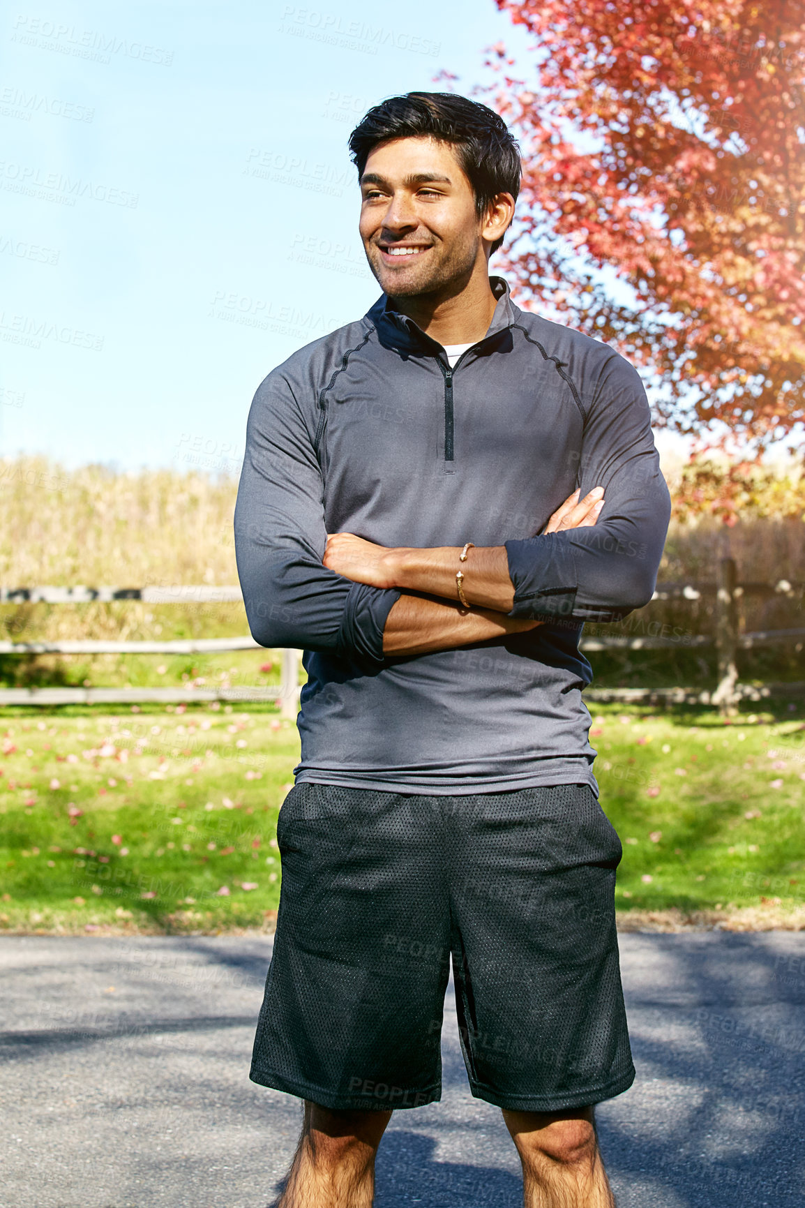 Buy stock photo Shot of a sporty young man standing outdoors