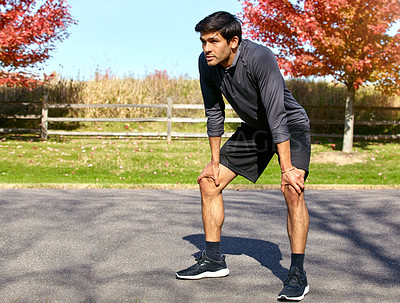 Buy stock photo Man, runner and break with rest for workout, exercise or outdoor training in countryside. Tired male person or athlete in recovery, breathing or fitness for cardio, endurance or stamina in nature