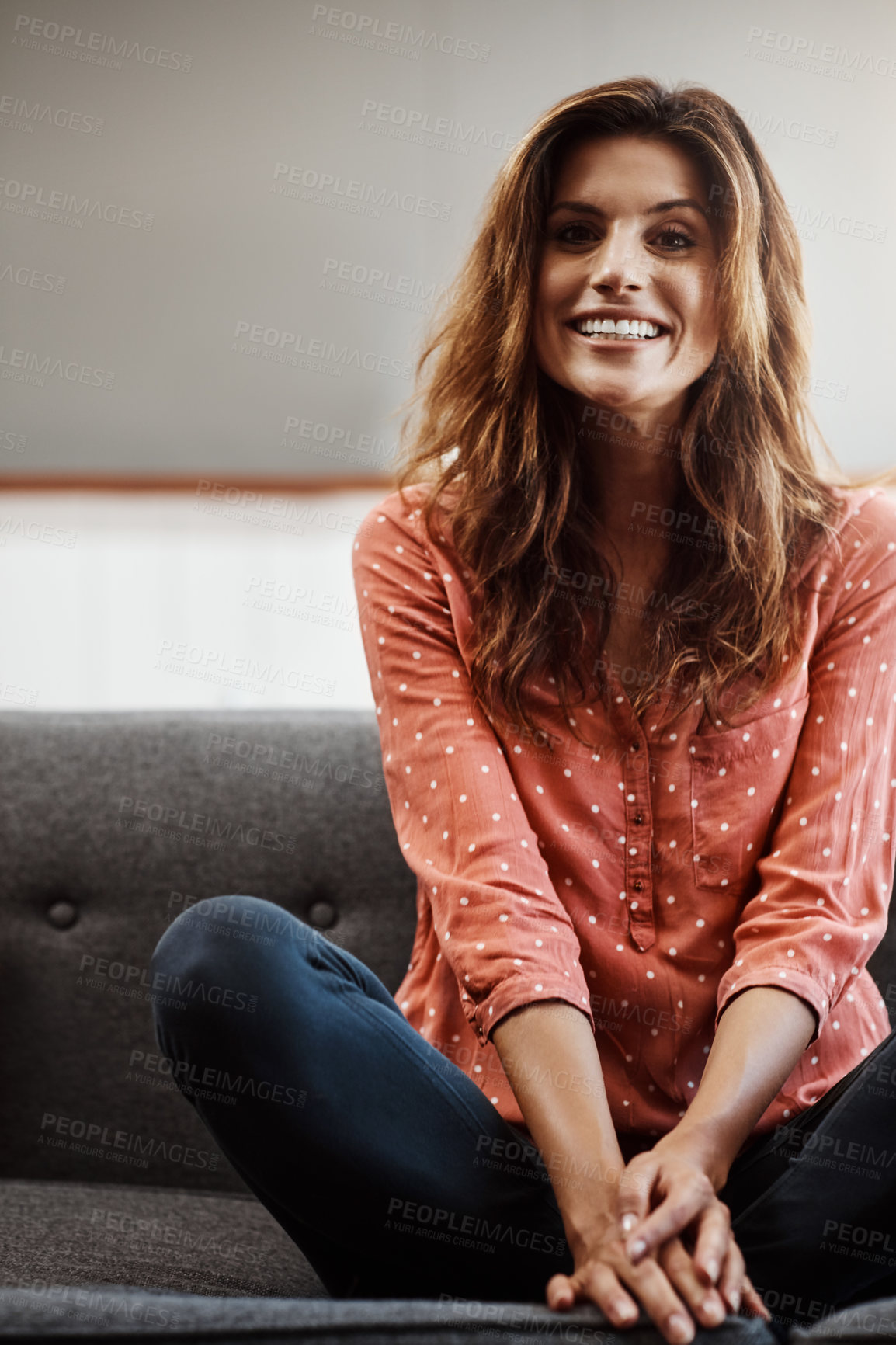 Buy stock photo Portrait of an attractive young woman relaxing on the sofa at home