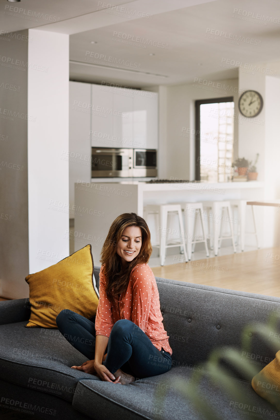 Buy stock photo Shot of an attractive young woman relaxing on the sofa at home