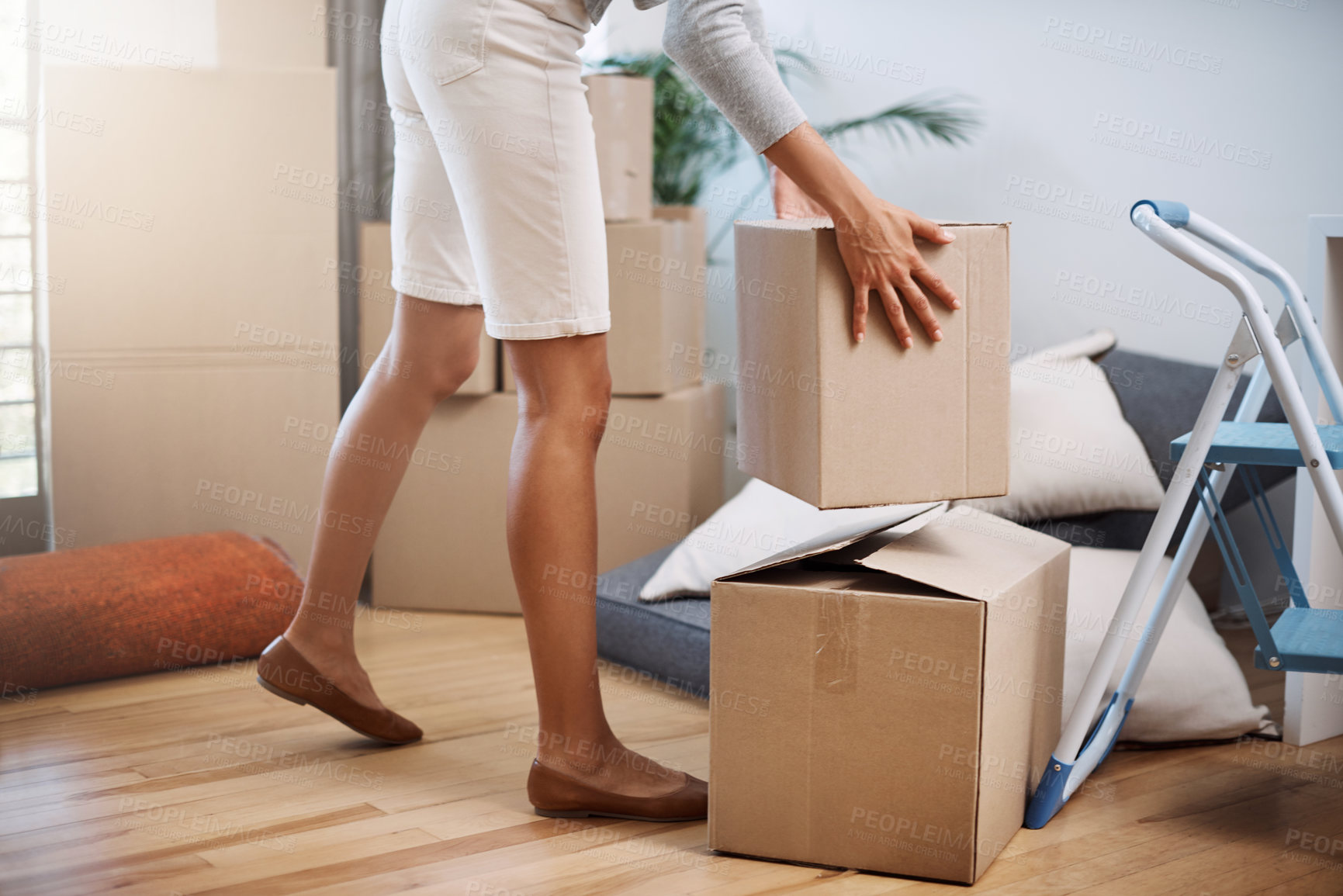 Buy stock photo Cropped shot of an unrecognizable young woman moving into her new house