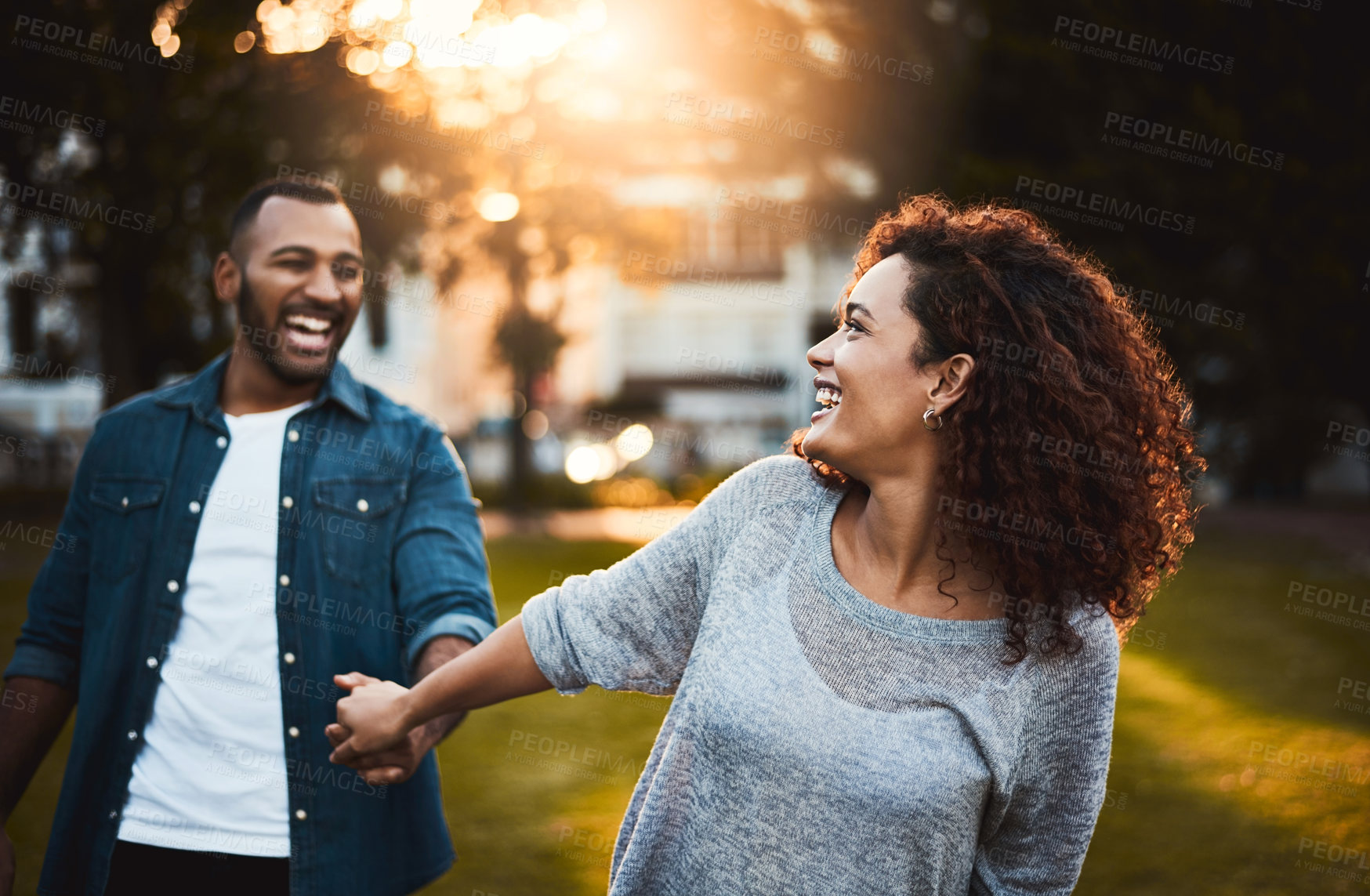 Buy stock photo Laugh, holding hands and couple in park walking for bonding, relationship and love outdoors. Nature, dating and man and woman for romance, affection and commitment on weekend to relax together