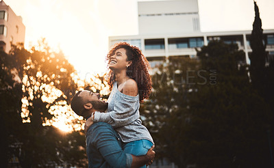 Buy stock photo Shot of a young couple having fun together outdoors