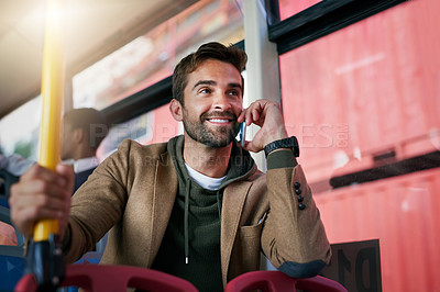 Buy stock photo Cropped shot of a handsome young man making a phonecall during his morning bus commute