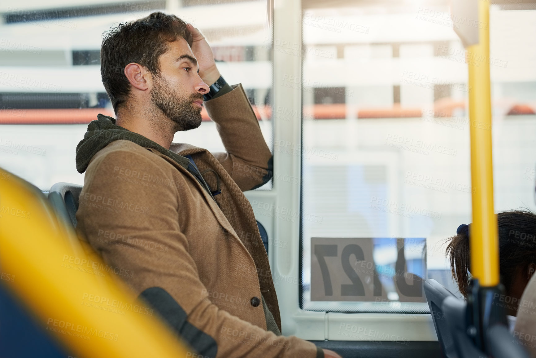 Buy stock photo Cropped shot of a handsome young man on his morning bus commute