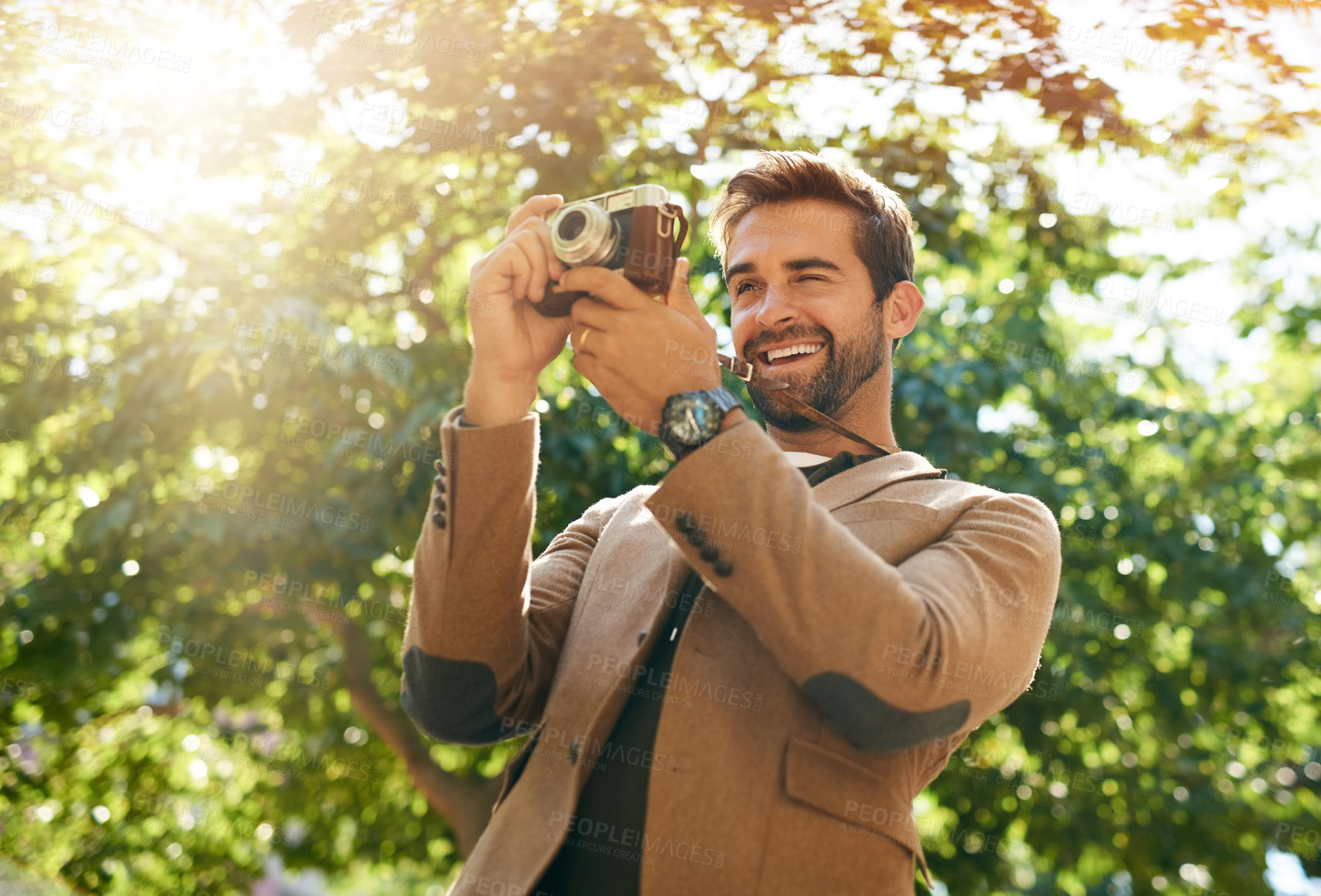 Buy stock photo Cropped shot of a handsome young man taking photographs during his morning commute