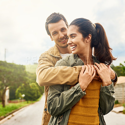 Buy stock photo Cropped shot of an affectionate young couple standing outdoors