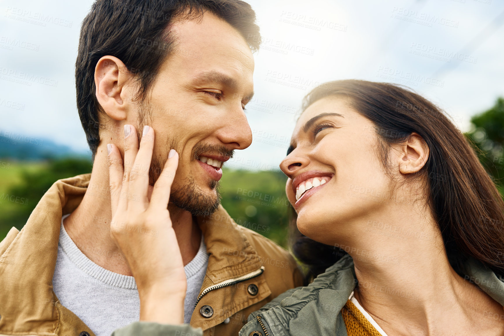 Buy stock photo Shot of an affectionate young couple outdoors