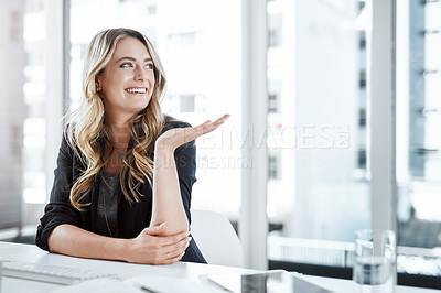Buy stock photo Shot of a young businesswoman gesturing with her hand at her desk in a modern office