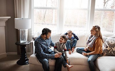 Buy stock photo Parents, children and family playing on lounge couch, talk and bonding with love, holiday or memory in morning. Mother, father and kids with games, care or connection to relax with smile in home