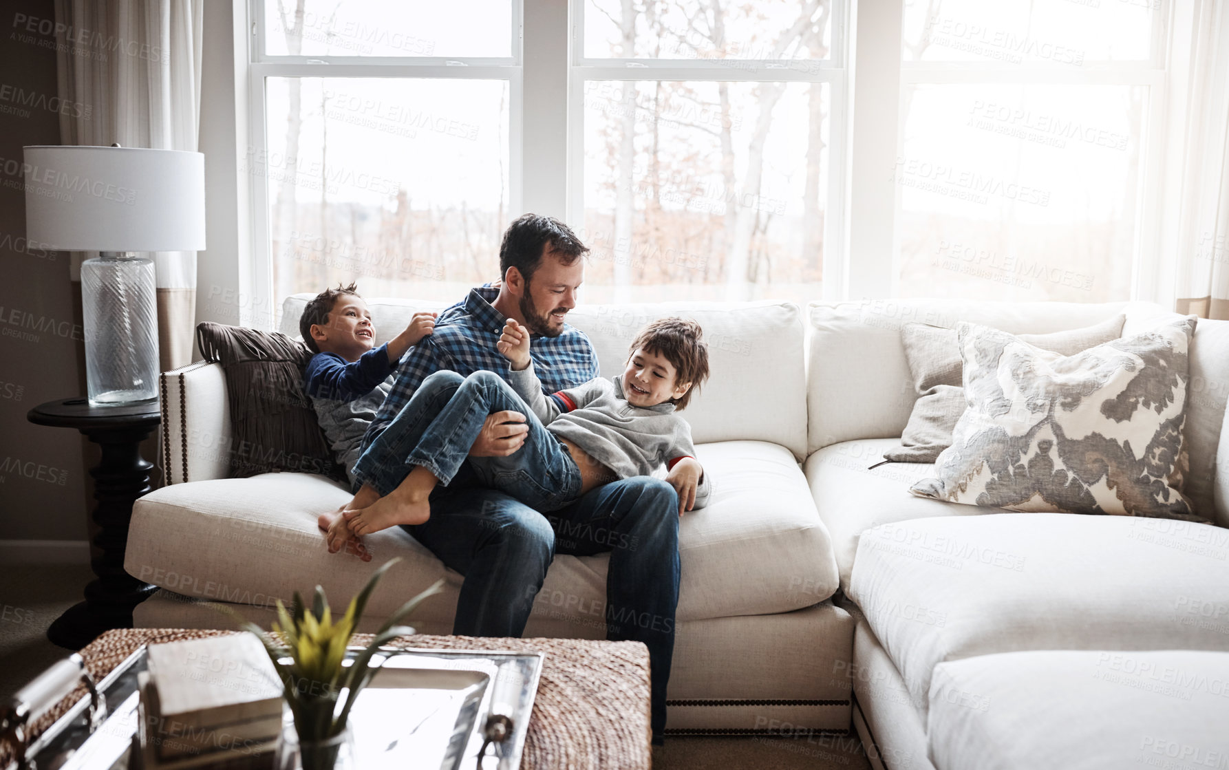 Buy stock photo Father, boy children at family home and playing in living room, fun and carefree with love, energy and happiness. Man play with kids on sofa, crazy and playful with laughter and joy in the house