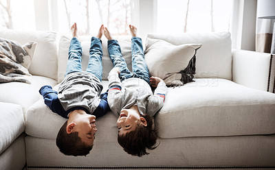 Buy stock photo Children upside down, playful and happy at family home for fun with sibling, brothers on sofa and relax in living room. Happy people, love and quality time together, kid boys play with laughing