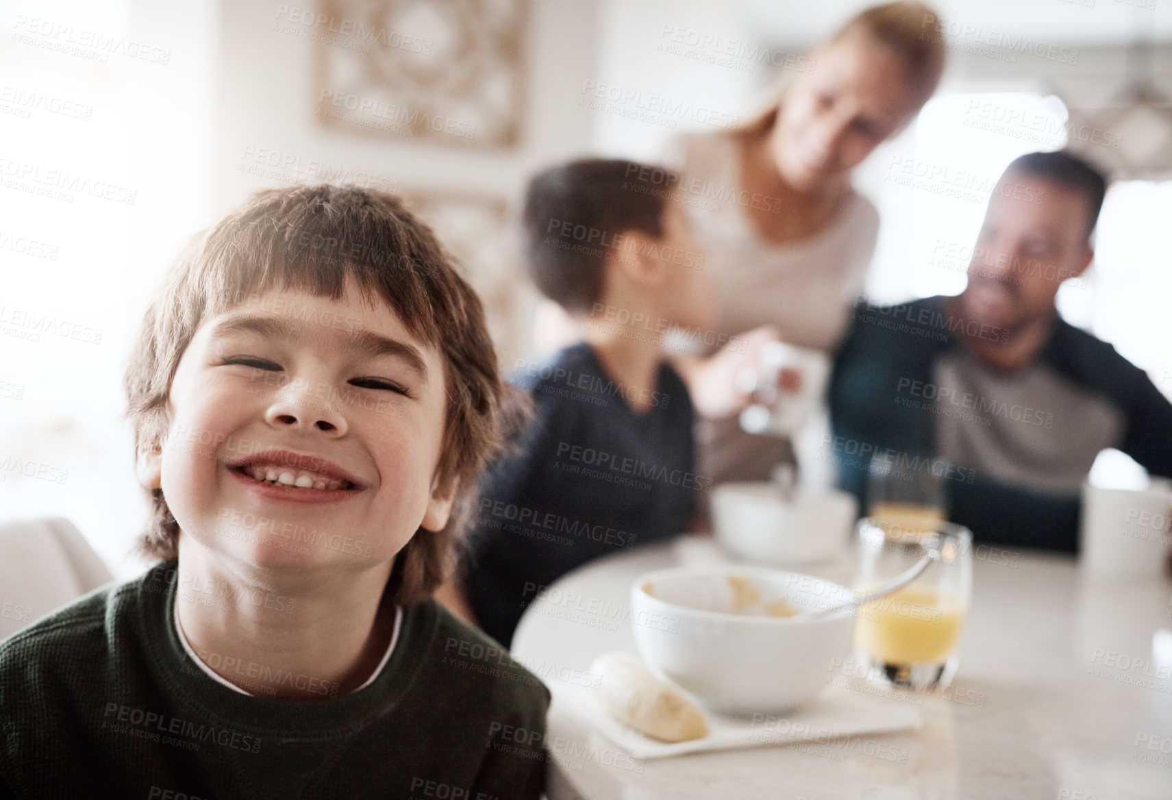 Buy stock photo Happy, breakfast and portrait of boy with family for at kitchen table for food, child development and bonding. Quality time, smile and happiness with son at home for diet, morning and nutrition
