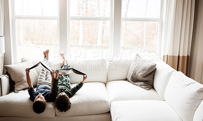 Buy stock photo Fun kids, bonding and reading books in education, learning or relax studying upside down on house living room or sofa. Children, storytelling and fantasy fairytale novel in creative home inspiration