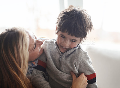 Buy stock photo Love, hug or mother and son in house with tickle, fun or morning games while bonding in their home together. Safety, laughter and kid with mom in a living room with support, protection and security