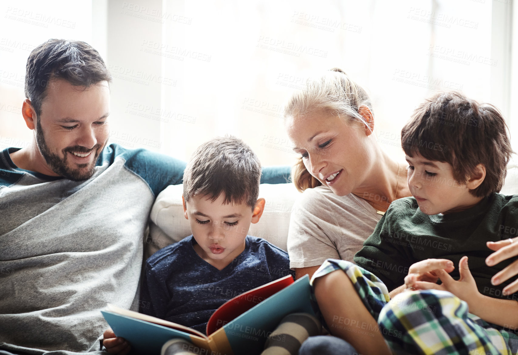 Buy stock photo Family, reading book together with parents and kids, happiness at home with story time and learning. Love, relationship and happy people bonding in living room, education and mom, dad with children