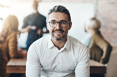 Buy stock photo Cropped portrait of a businessman sitting in the boardroom during a presentation
