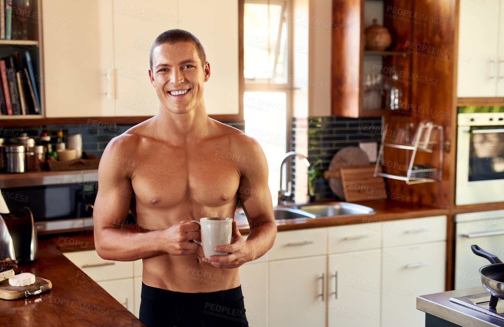 Buy stock photo Cropped shot of handsome young shirtless man drinking a cup of coffee in the kitchen at home