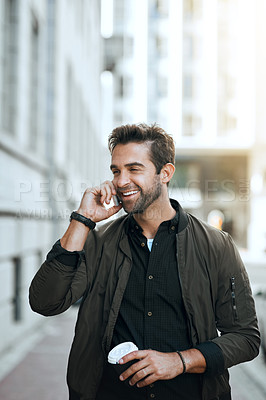 Buy stock photo Cropped shot of a handsome young man making a phonecall while traveling through the city