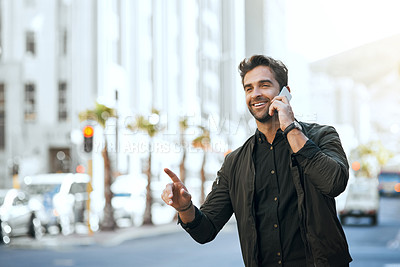 Buy stock photo Cropped shot of a handsome young man making a phonecall while traveling through the city
