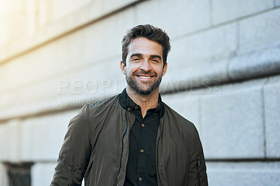 Buy stock photo Cropped portrait of a handsome young man in the city