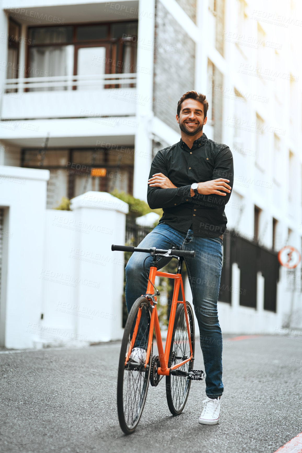 Buy stock photo Full length portrait of a handsome young man traveling through the city by bike