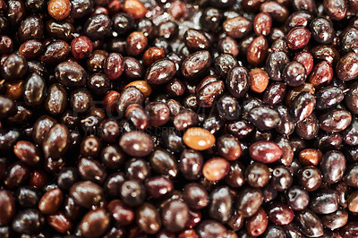 Buy stock photo Shot of numerous amounts of red olives being displayed at a market during the day